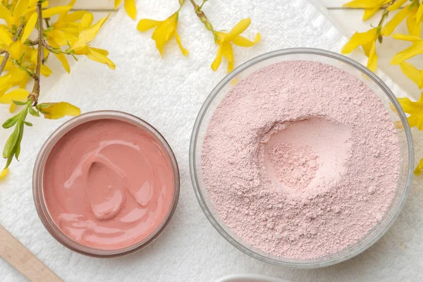 Cosmetic clay. Pink cosmetic clay in different types on a white wooden table. face mask and body. care products. spa. top view.