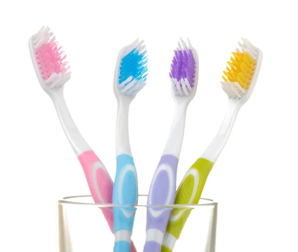 Multi Colored Toothbrushes Glass Beaker White Isolated Background Oral Hygiene — Stock Photo, Image