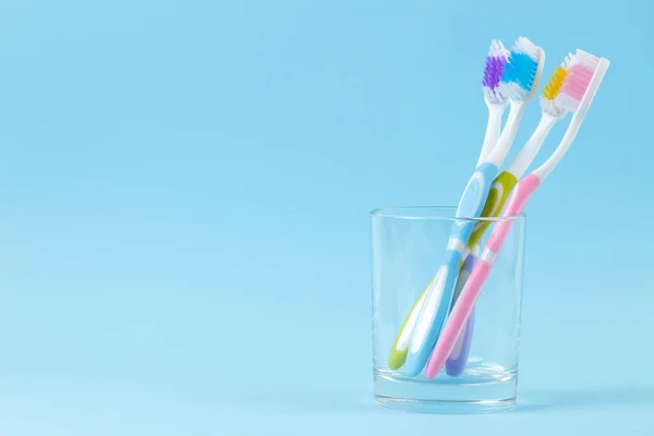 Oral Hygiene Multi Colored Toothbrush Glass Gentle Blue Background Space — Stock Photo, Image