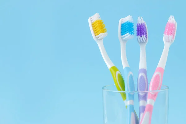 Oral Hygiene Multi Colored Toothbrush Glass Gentle Blue Background Space — Stock Photo, Image
