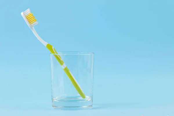 Oral Hygiene Green Toothbrush Glass Gentle Blue Background Space Text — Stock Photo, Image