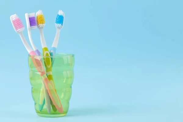 Oral Hygiene Multi Colored Toothbrush Glass Gentle Blue Background Space — Stock Photo, Image