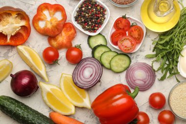 Yemek salatası için malzemeler. Çeşitli sebze ve baharatlar havuç, domates, soğan, salatalık, biber ve hafif bir arka plan üzerinde arugula. üst görünüm.