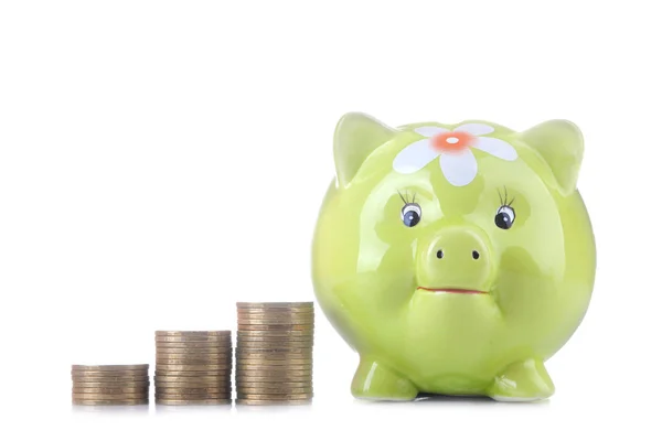 Green pig moneybox and money on white isolated background. Finance, savings, money.