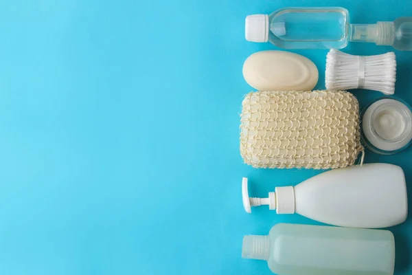 Personal hygiene products. Body care cosmetics. White bottles and vials on a blue background. SPA. Relax. Top view