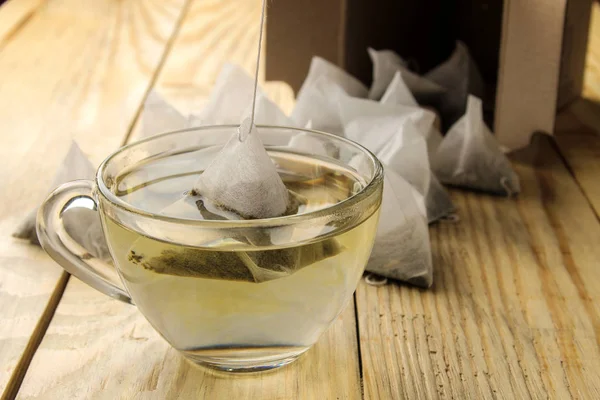 Tasse Mit Tee Und Teebeutelpyramide Vorhanden Nahaufnahme Auf Einem Holztisch — Stockfoto