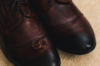 İki altın geniş erkek ayakkabıları üzerinde bulunan Alyans, kahverengi deriden yapılmış