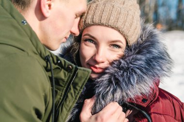 Aşk parkta bir açık güneşli kış gününde, sarılma, güzel genç çift yakın çekim