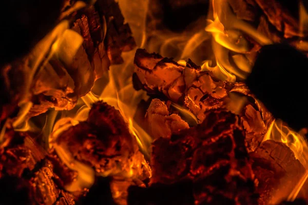 Campfire bright heat flame background. Bonfire bright yellow orange flame. Strong fire close up. Holiday cosy chimney fireplace.