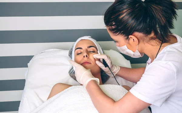 Woman getting rf lifting in her face in clinic — Stock Photo, Image