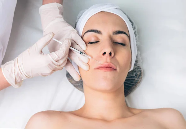 Closeup of woman getting cosmetic injection in the face — Stock Photo, Image