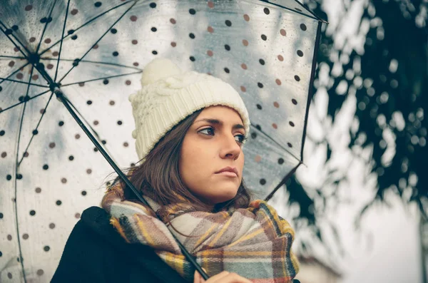 Young girl holding umbrella in an autumn rainy day — Stock Photo, Image