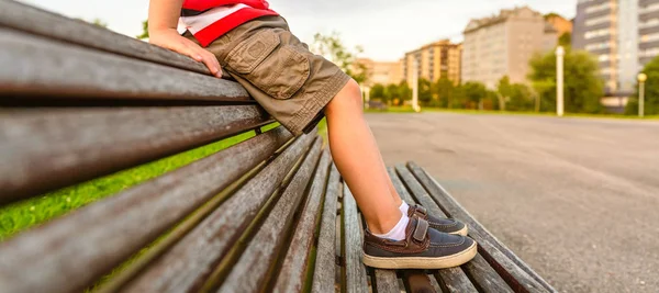 Closeup Boy Legs Short Pants Sitting Top Wooden Bench Park — Stock Photo, Image