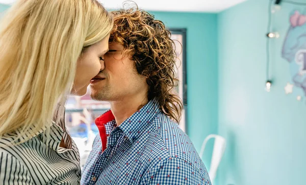 Couple kissing in a cafe — Stock Photo, Image