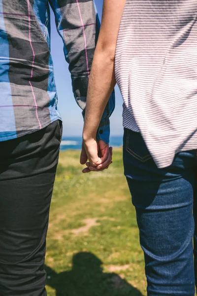 Unrecognizable couple holding hands — Stock Photo, Image