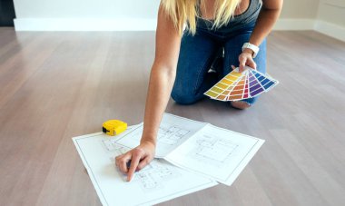 Young woman looking house plans clipart