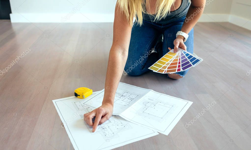 Young woman looking house plans