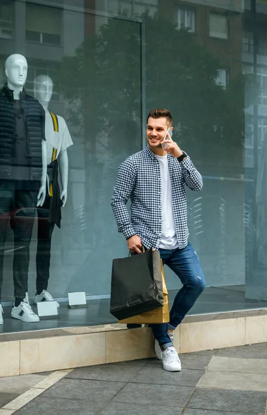 Young man with shopping bags — Stock Photo, Image