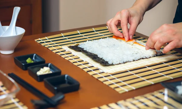 Chef-kok handen plaatsen ingrediënten op rijst — Stockfoto