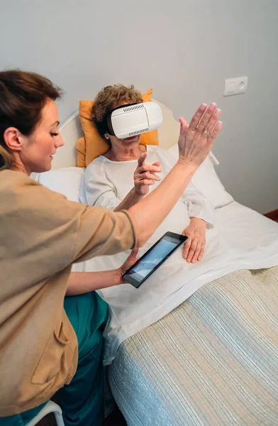 Older patient using virtual reality glasses