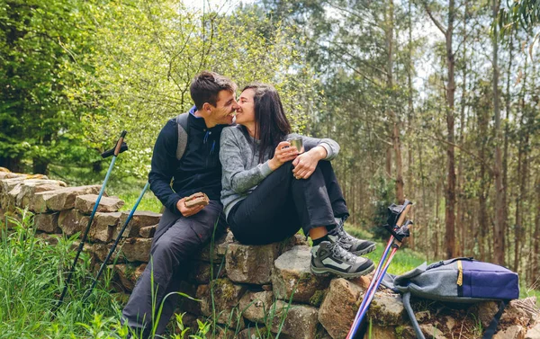 Couple about to kiss while making a break to do trekking — Stock Photo, Image