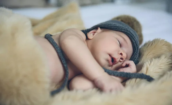 Baby girl with pompom hat sleeping — Stock Photo, Image