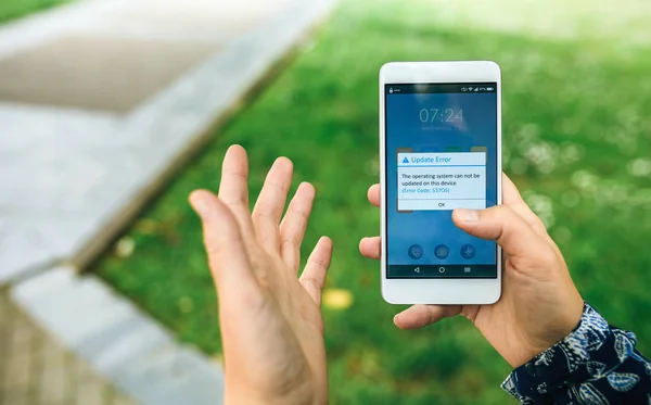 Руки держат телефон с текстом ошибки обновления на экране — стоковое фото
