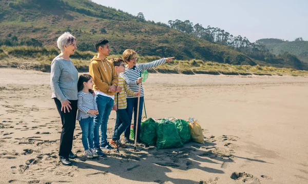 Добровольцы позируют после уборки пляжа — стоковое фото