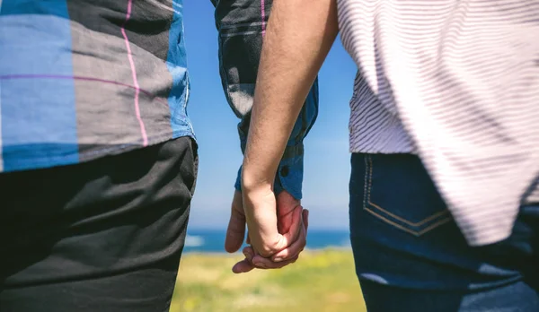 Unrecognizable couple holding hands — Stock Photo, Image