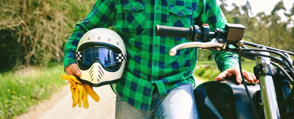 Hombre posando con motocicleta, casco y guantes — Foto de Stock