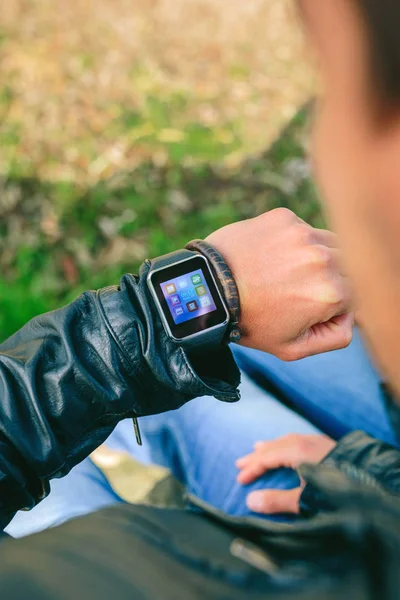 Unrecognizable young man looking at his smartwatch