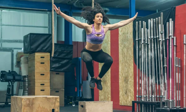 Athletes exercising jumping wooden box — Stock Photo, Image