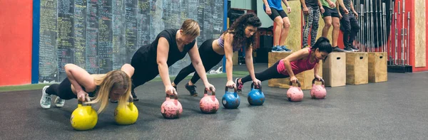 Sportvrouwen training met kettlebells en sporters die box jumps doen — Stockfoto