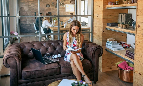 Businesswoman working checking her agenda in a coworking office — Stock Photo, Image