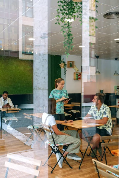 Camarera tomando orden del cliente con la tableta — Foto de Stock