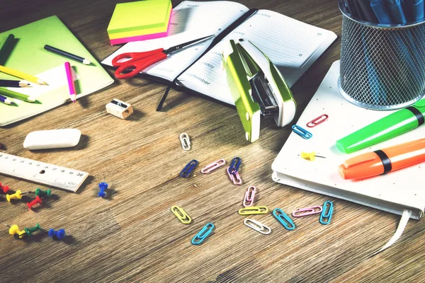 Colorful school supplies over wooden desktop — Stock Photo, Image