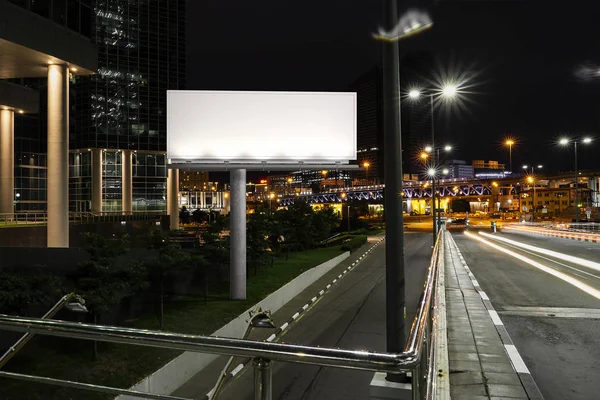 Blank illuminated billboard near road and tunnel at night. 3d rendering