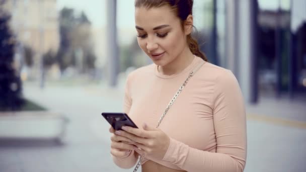 Gros plan de jeunes femmes attrayantes textos messages sur téléphone mobile — Video