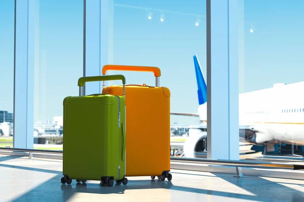 Zwei moderne farbige Blanko-Koffer mit Flughafen auf Hintergrund, 3D-Rendering. — Stockfoto