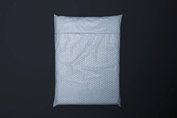 White realistic packet in transparent wrapping on black background. 3d rendering — Stock Photo, Image