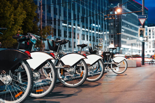 Парковка велосипедов в ночное время в центре города. Концепция современного транспорта
.
