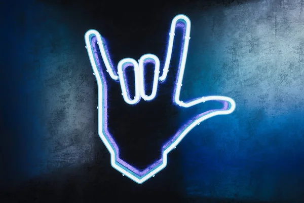 Hand in rock and roll sign made from neon lamps on dark background. 3d rendering.