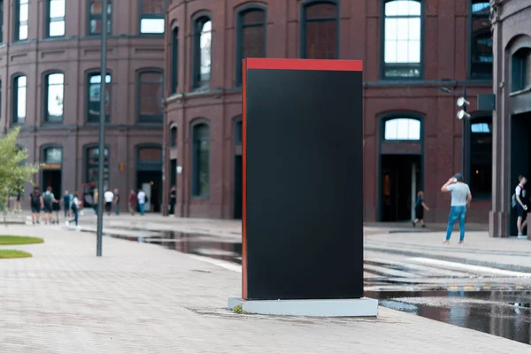 Blank black outdoor banner stand next to modern building. 3d rendering.