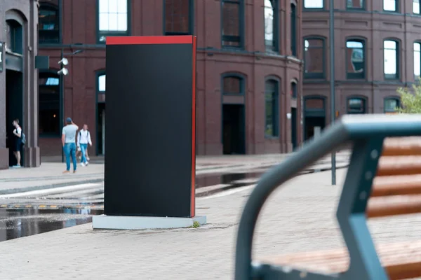 Blank black outdoor banner stand next to modern building. 3d rendering.