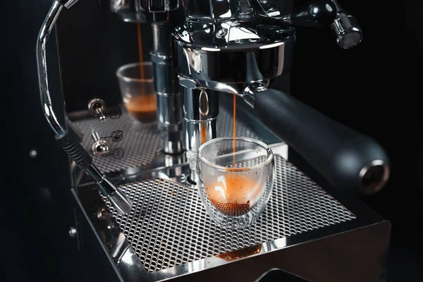 Metallic clean silver coffee machine in process of making fresh coffee. Preparing coffee at home. Home barista.