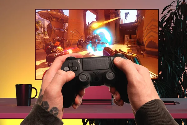 Close up of Man Hands Holding Wireless Joysticks On Foreground. Modern TV Set With Shooter Video Game On Background. 3d rendering — Stock Photo, Image