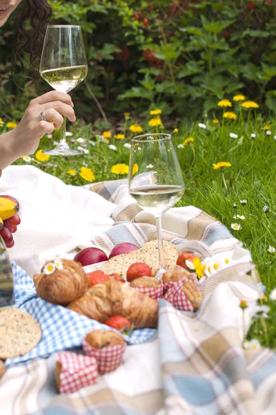 Two wine goblets, fresh strawberry, honey and wine are served for summer romantic picnic. Copy space