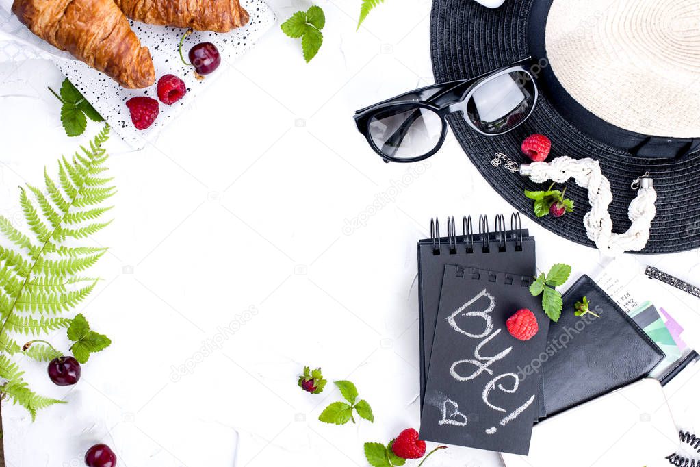 Womens accessories, lady on vacation. Passport, notebook and breakfast. Fresh berries, croissants and coffee. White background. Copy space. Flat lay.