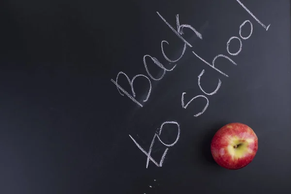 Black school board with the text. The apple is red for lunch and snack after classes. Copy space
