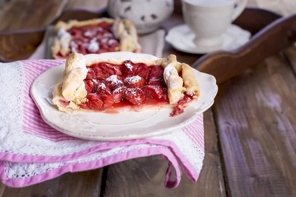 Sweet home-made pie for breakfast and a cup of black tea, on a krchovom wooden tray. free space for text or advertising.